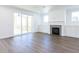 Bright living room with a fireplace, built-ins, wood floors, and sliding glass doors at 121 Big Bradley Way, Wendell, NC 27591