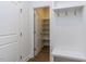 Bright mudroom with white wainscoting, coat hooks, bench, and walk-in closet for added storage space at 121 Big Bradley Way, Wendell, NC 27591