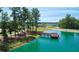 Aerial view of scenic pond and wooden dock, surrounded by lush greenery and homes at 121 Big Bradley Way, Wendell, NC 27591