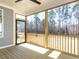 Screened-in back porch with wood floors overlooking a wooded backyard at 121 Big Bradley Way, Wendell, NC 27591
