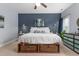 Bright bedroom featuring dark blue accent wall, overhead fan, and a bed frame with built-in storage baskets at 126 Owen Towne Rd, Chapel Hill, NC 27516