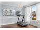 Home gym with a treadmill, art, and natural light from a large window at 126 Owen Towne Rd, Chapel Hill, NC 27516