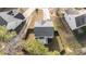 An aerial view of the house with a gray roof, small patio, and a wooden fenced-in backyard at 1305 Turks Head Ct, Zebulon, NC 27597