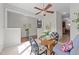 Bright breakfast nook with a glass table, rattan furniture and open view to the kitchen area at 1305 Turks Head Ct, Zebulon, NC 27597