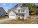 Charming two-story home with grey siding, red shutters, and a two-car garage at 1305 Turks Head Ct, Zebulon, NC 27597