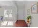 This is the foyer with hardwood floors, a view of the front yard, and a decorative table and vase at 1305 Turks Head Ct, Zebulon, NC 27597