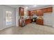 Spacious kitchen with wooden cabinets, stainless steel appliances, and ample counter space near a glass panel door at 1305 Turks Head Ct, Zebulon, NC 27597