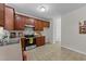 Functional kitchen with wood cabinetry, stainless steel appliances, and a view into an adjoining room at 1305 Turks Head Ct, Zebulon, NC 27597