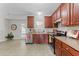 Well-lit kitchen featuring stainless steel appliances, wooden cabinets, and a door leading to the outdoors at 1305 Turks Head Ct, Zebulon, NC 27597