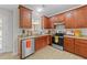 Well-equipped kitchen featuring stainless steel appliances, wood cabinets, and neutral countertops at 1305 Turks Head Ct, Zebulon, NC 27597