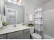 Clean bathroom with shower/tub combo and gray vanity at 131 Kinnakeet Dr, Durham, NC 27704