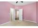 Pink bedroom with two closets and access to hallway at 131 Kinnakeet Dr, Durham, NC 27704