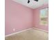 Bright bedroom with pink walls and ceiling fan at 131 Kinnakeet Dr, Durham, NC 27704