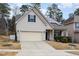 House exterior with a two-car garage and landscaping at 131 Kinnakeet Dr, Durham, NC 27704