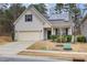 House exterior with solar panels, a two-car garage, and well-manicured landscaping at 131 Kinnakeet Dr, Durham, NC 27704