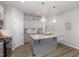 Modern kitchen with gray cabinets, granite countertops, and a large island at 131 Kinnakeet Dr, Durham, NC 27704