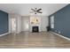 Spacious living room featuring a fireplace, wood-look floors, and blue accent wall at 131 Kinnakeet Dr, Durham, NC 27704