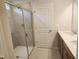 Bathroom featuring tiled walk-in shower, double sink vanity, and neutral finishes at 139 Grove Township Way, Angier, NC 27501