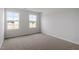 Bright bedroom featuring neutral carpet, and two windows that provide ample natural light at 139 Grove Township Way, Angier, NC 27501