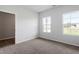 A bedroom featuring carpet floors and two windows offering plenty of natural light at 139 Grove Township Way, Angier, NC 27501