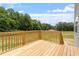 Outdoor wooden deck provides ample space for relaxation or entertaining with a view of greenery at 139 Grove Township Way, Angier, NC 27501