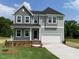 Charming two-story home featuring a well-manicured lawn and a classic architectural design at 139 Grove Township Way, Angier, NC 27501