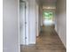 Bright hallway with neutral walls and flooring leads to a spacious living area and outdoor deck at 139 Grove Township Way, Angier, NC 27501