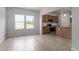 Open-concept kitchen featuring stainless steel appliances and ample natural light from large windows at 139 Grove Township Way, Angier, NC 27501