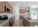 A kitchen featuring wooden cabinets, granite counters, and stainless steel appliances at 139 Grove Township Way, Angier, NC 27501