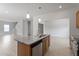 Kitchen island features granite countertops, stainless steel appliances, and wooden cabinetry at 139 Grove Township Way, Angier, NC 27501
