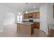 Well-lit kitchen with a center island, granite countertops, and stainless steel appliances open to the living space at 139 Grove Township Way, Angier, NC 27501