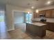 Open kitchen featuring granite countertops, stainless steel appliances, and a center island at 139 Grove Township Way, Angier, NC 27501