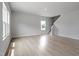 An open living space with light wood floors, staircase, and a view to the outside at 139 Grove Township Way, Angier, NC 27501