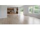 Bright living room boasts wood floors, a modern kitchen, and sliding glass doors to a deck at 139 Grove Township Way, Angier, NC 27501
