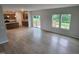 Open-concept living room with bright windows and a modern kitchen in the background at 139 Grove Township Way, Angier, NC 27501