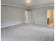 Bright, neutral-toned main bedroom with double doors to bathroom and closet spaces at 139 Grove Township Way, Angier, NC 27501