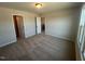 A neutral-toned bedroom features a ceiling light, carpeted floor, and a door to the hallway at 140 Wild Turkey Way, Lillington, NC 27546