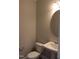 Small bathroom with pedestal sink and round mirror at 1410 Reading Ct # 92Kl, Burlington, NC 27217