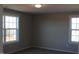 Well-lit bedroom featuring two windows at 1410 Reading Ct # 92Kl, Burlington, NC 27217