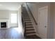 Staircase with dark wood and metal railing leading to the upper level at 1410 Reading Ct # 92Kl, Burlington, NC 27217