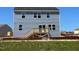 The home features a backyard with a small wooden deck, and a light blue siding at 157 Grove Township Way, Angier, NC 27501