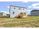 Exterior view of a two-story home with a wooden deck and ample yard space at 157 Grove Township Way, Angier, NC 27501