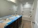 Bright bathroom featuring a double sink vanity and a bathtub with shower at 157 Grove Township Way, Angier, NC 27501