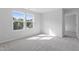 Spacious bedroom with neutral carpet, two windows, and light walls, creating a serene atmosphere at 157 Grove Township Way, Angier, NC 27501
