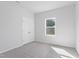 Clean and carpeted bedroom with a closet and a bright window at 157 Grove Township Way, Angier, NC 27501