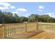Spacious wooden deck with natural wood railings and a view of lush greenery at 157 Grove Township Way, Angier, NC 27501
