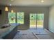 Bright dining area with sliding glass doors leading to a wooden deck and scenic views at 157 Grove Township Way, Angier, NC 27501