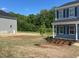 The exterior of this two-story home features a well-manicured lawn and classic architectural details at 157 Grove Township Way, Angier, NC 27501