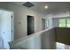 Upstairs hallway featuring multiple doorways and natural light from nearby windows at 157 Grove Township Way, Angier, NC 27501