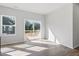Open living space with natural light, sliding glass doors to a deck, and wood-look floors at 157 Grove Township Way, Angier, NC 27501